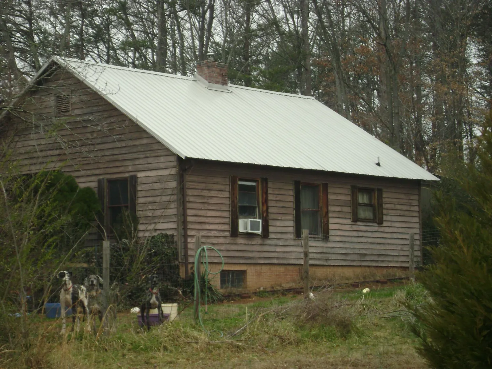 White metal roof on an old wood sided farmhouse, from a Asphalt Shingle Roof Repair job in Tuskegee Institute